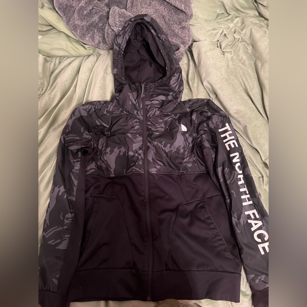 North face black zip up rain jacket. Has a hood. Keeps you very warm and dry.